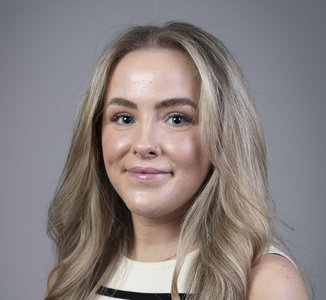 Corporate style head and shoulders portrait photo of Georgie Slater, Operations Coordinator at the Health Services Safety Investigations Body.