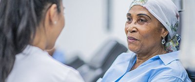 A nurse speaks to a cancer patient.