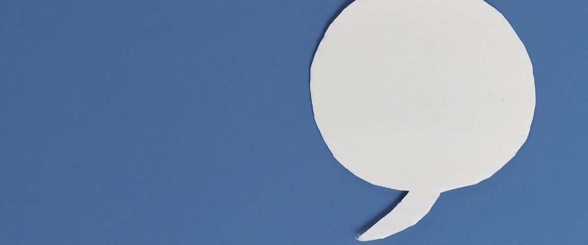 White speech bubble on a blue background.