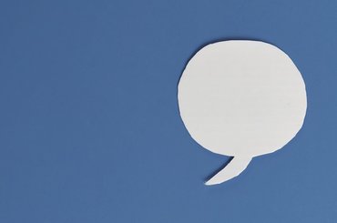 White speech bubble on a blue background.