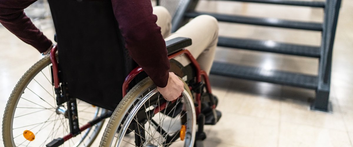 A male wheelchair user is unable to use an internal staircase for access to the next level.