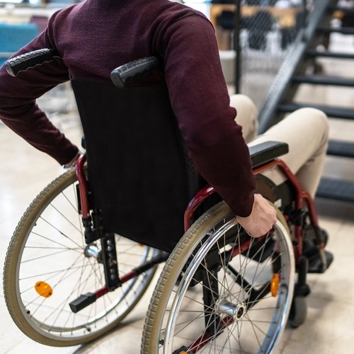 A male wheelchair user is unable to use an internal staircase for access to the next level.
